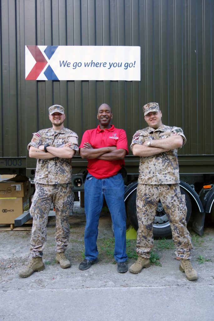 Soldiers pose with an Exchange associate.