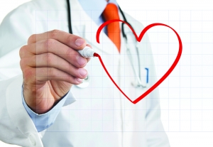 Male doctor drawing heart symbol at the whiteboard