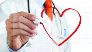 Male doctor drawing heart symbol at the whiteboard