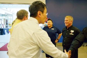 Vice President Enterprise Planning Paul Jen greets associates while traveling with Director/CEO Tom Shull in the Pacific Region.