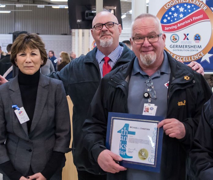 Omni Channel SVP Mickey Bradford (center) and EVP/Chief Logistics Officer Karen Stack congratulate associate Michael Chastain at the grand opening of the Germersheim Distribution Center.