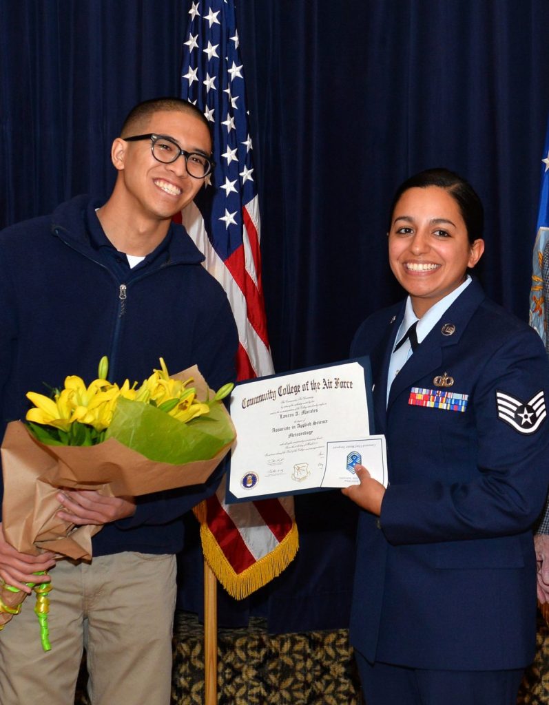 Kris Cubacub presents his wife, Lauren Morales, with flowers after she received a meteorology degree.