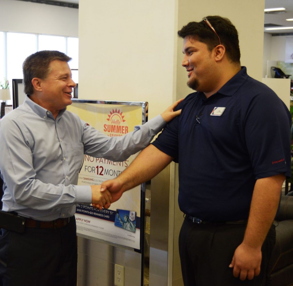 Associate Nicholas Goya from Okinawa welcomes COO Dave Nelson to his facility.