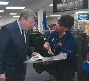 Associate Marta Antonio shows Exchange Director/CEO Tom Shull her scrapbook.