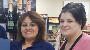 ROBINS AFB, Ga. - Maria Christina Negron, center, receives an award from LP's Brittany Gentry and Store Manager Maria Hood for helping the store avoid a loss after she caught a customer trying to sneak six cases of beer and a bottle of Crown Royal out of the store in a shopping bag.