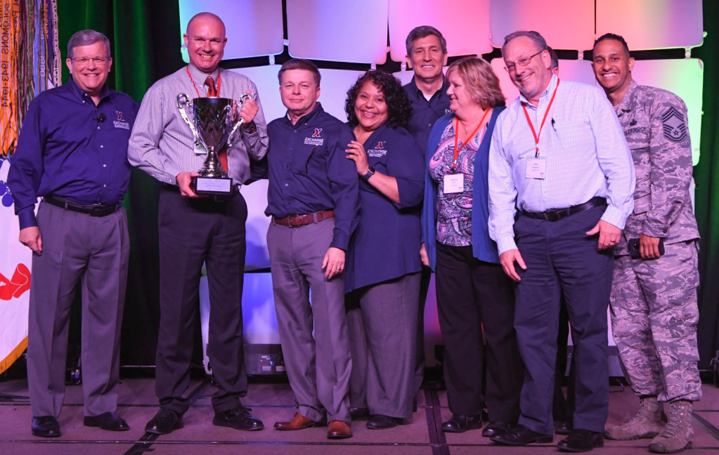 The UK Consolidated Exchange was awarded the Director/CEO Cup in the Large category at the annual Main Store Managers/General Managers Conference. Pictured (left to right): Exchange Director/CEO Tom Shull; UK Consolidated General Manager Edward Hicks; Chief Operating Officer Dave Nelson; President Ana Middleton; Chief Administrative Officer Phil Stevens; RAF Lakenheath Exchange Main Store Manager Sabine Brink; RAF Mildenhall Exchange Main Store Manager John Monaghan; and Chief Master Sgt. Luis Reyes.