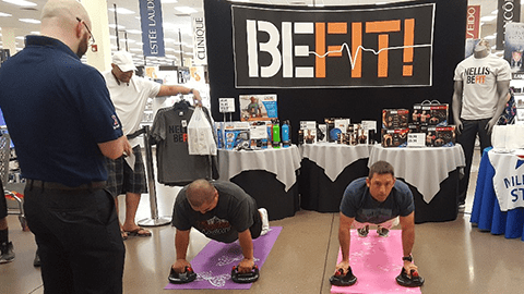 NELLIS AFB, Nev - Associate Paul Ackerly officiates the perfect pushup contest during a “Healthy Lifestyle” event that featured the Exchange's Be Fit products.