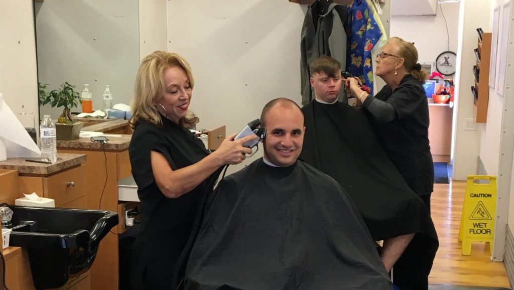 Service members get their haircuts at the barber shop set up at Tyndall AFB, Fla.