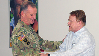 Fort Drum General Manager James Osborne, right, shakes hands with Division Commander Maj. Gen. Walter Piatt. The commander stopped by the Exchange to thank Osborne for his service to the Soldiers.