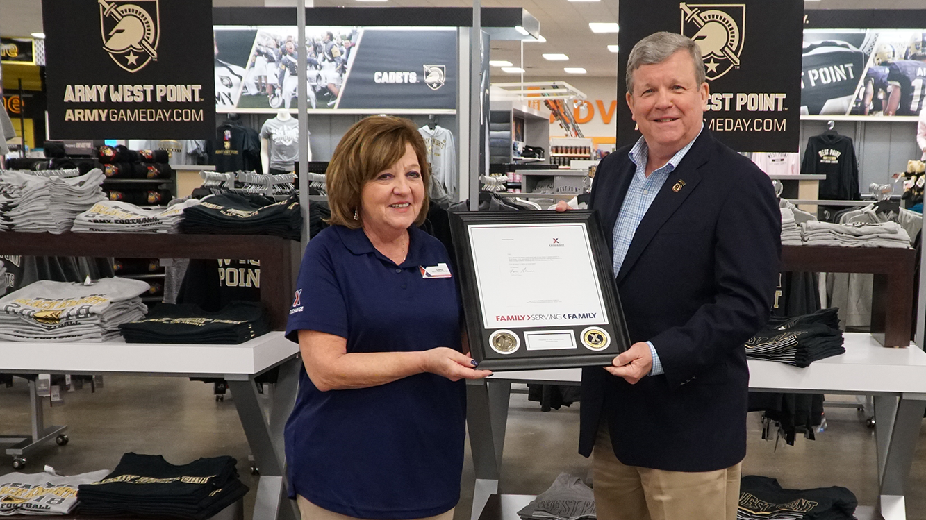 Debi Deleno-Dilello is honored by Exchange Director/CEO Tom Shull for her work managing the Military Clothing Store at the U.S. Military Academy in West Point, N.Y.