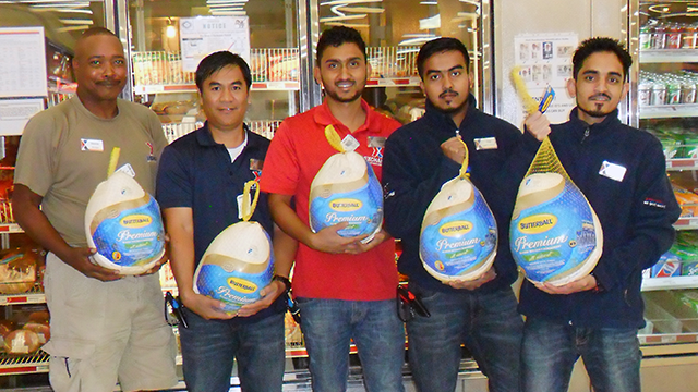 Exchange associates help load turkeys into the freezer at the Al Udeid Blatchford-Preston Complex Exchange in Qatar. From left: Dennis Dawson, store manager; Jofre Palinlin, inventory control associate; Prakash Rijal, inventory control associate; Kutub Uddin, sales associate; and Prem Khadka, customer service leader.