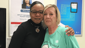 Central Region Senior Vice President Marla Smith, left, hugs Offutt AFB Manager Patti Griffin after recognizing Griffin for the kindhearted efforts with a valued customer.