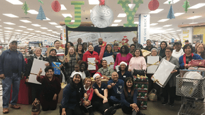 Family members who had their layaways paid by an anonymous donor pose with Exchange associates.