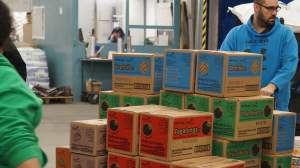 Associates with girl Scout cookies in Exchange warehouse