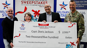 Left to right: Exchange West Coast Regional Vice President Robert Rice; sweepstakes winner (Ret.) Capt. Doris Jackson; Exchange General Manager Matthew Beatty; and 99th Air Base Wing Vice Commander Col. Michael T. Davis.