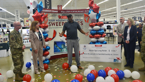 Col. Jeffrey Carter, 502nd Security Forces Group Commander; Kimberly Toney, Executive Director, Air Force Personnel Center; retired Master Sgt. Leroy Porter, Exchange Your Holiday Bill Is On Us Sweepstakes grand-prize winner; Jim Jordan, Exchange Chief Financial Officer/Executive Vice President; Jami Richardson, Senior Vice President, Exchange Credit Program join in the celebration.