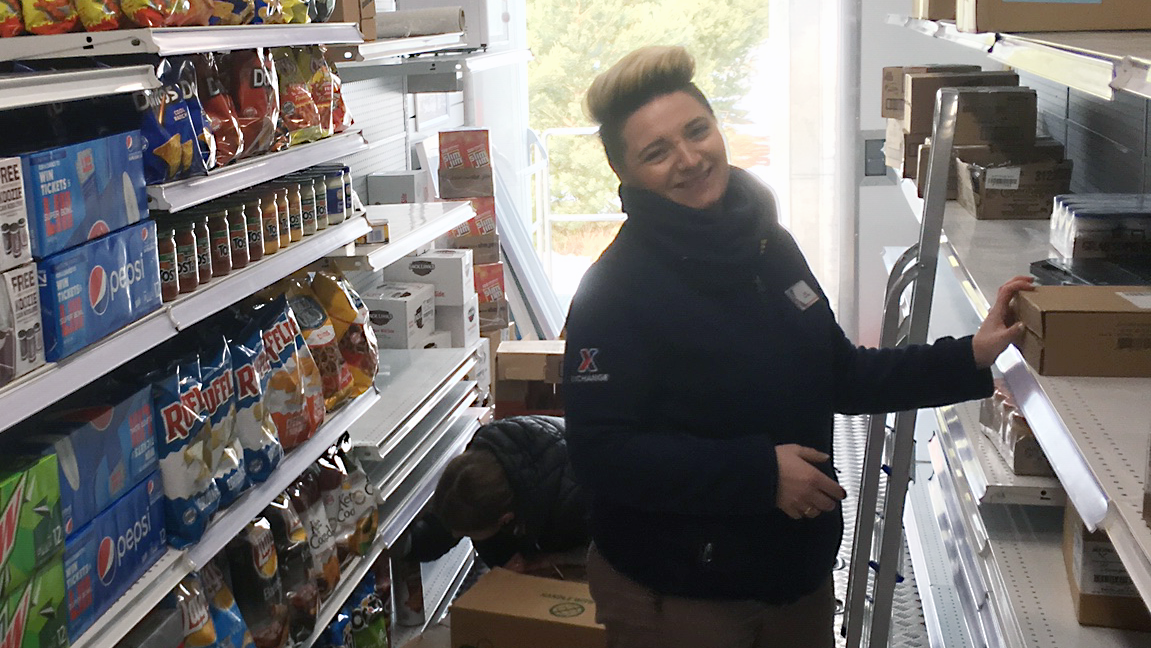 Adriana Piechalak (front), and Oliwia Kołodziejczak stuff the shelves with inventory ahead of the MFE’s opening Feb. 9 in Turon.