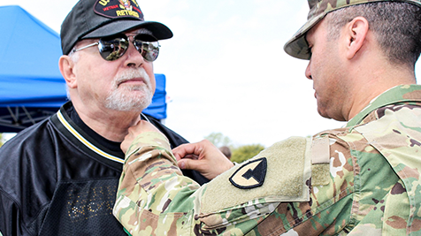 Vietnam Vet getting lapel pin from installation commander.