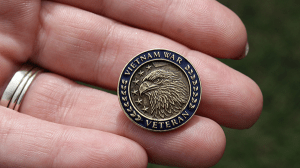 Vietnam Veteran lapel pin in hand.