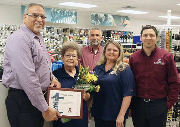 Eighty-four-year-old Charlsie Dean celebrates her golden anniversary with the Exchange at the Fort McClellan National Guard Troop Store. Joining her in a picture are, left to right, Jesse Martinez, southeast region vice president, who is presenting her with a Thanks award; Don Sydlik, general manager; Lucretia Palmer, McClellan store manager; and John Seward, regional HR manager.