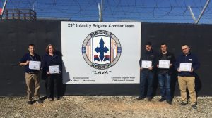 Balkans General Manager Lori Maggard; managers Naim Rashiti, Gazmend Mehmeti and Azem Hajrullahu; and barber Ergyn Pantina, display their certificates from battle-group commanders