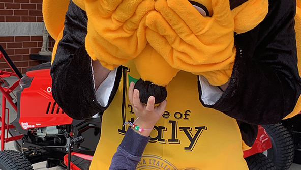 FORT LEE, Va. - A little girl squeezes the nose of the Exchange safety bee mascot during the grand opening of the store's outdoor living center. Playing the mascot was Loss Prevention's Cooper Stegmann.