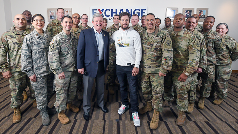 Actor Mark Wahlberg stands with Exchange Director/CEO Tom Shull and Soldiers and Airmen assigned to HQ.