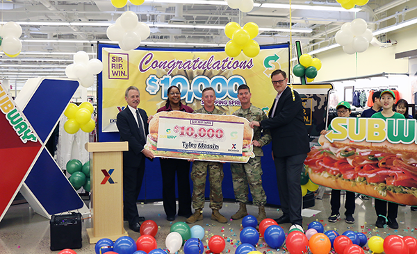 PFC Tyler Massie, center, stands with Pacific Region Vice President Rick Fair, Main Store Manager Debra Melton, BG Patrick Donohoe and General Manager Scott Bonner.