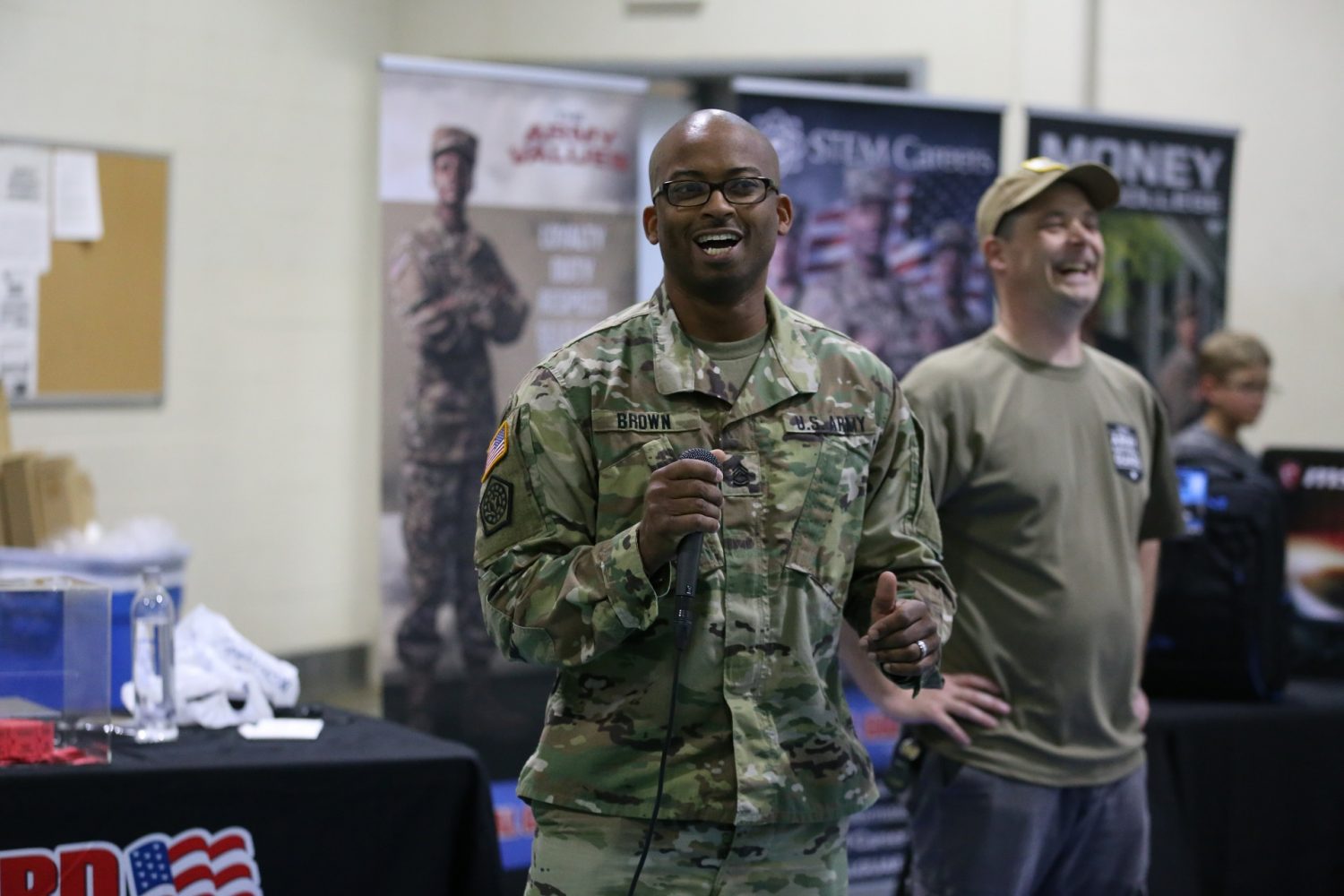 Sgt. 1st Class Brown, the winner of the Camp Mabry event, addresses the crowd by microphone