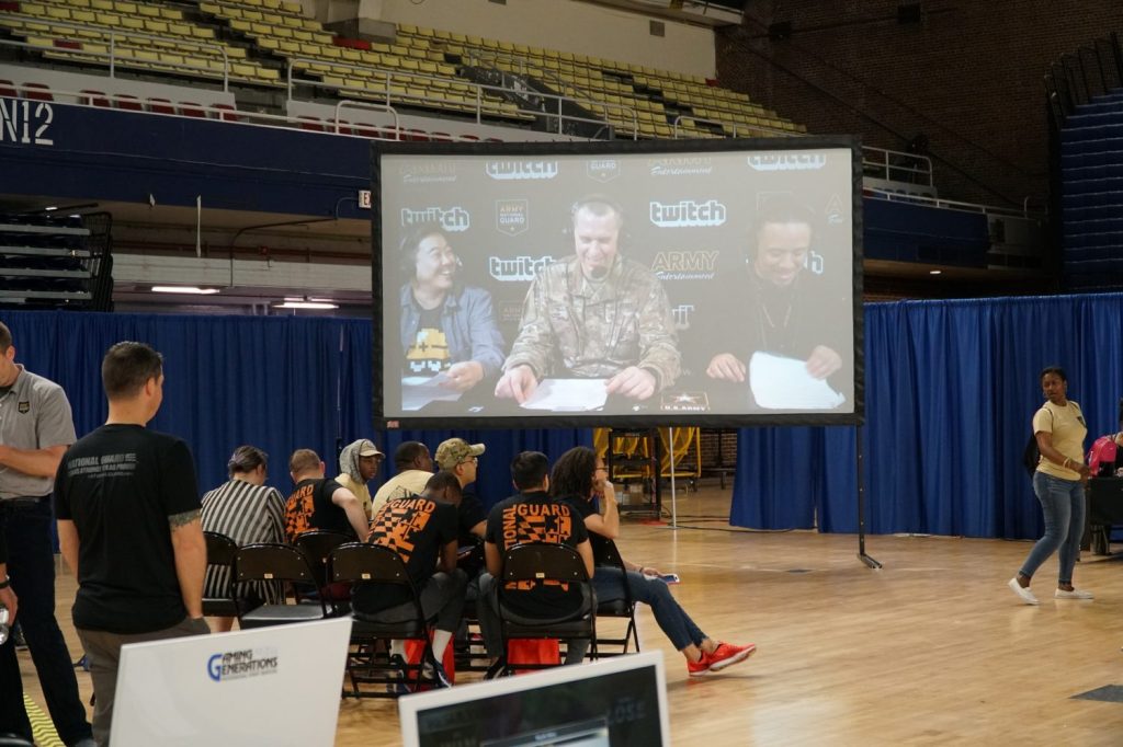 Spectators watch the Twitch commentary team on a big screen