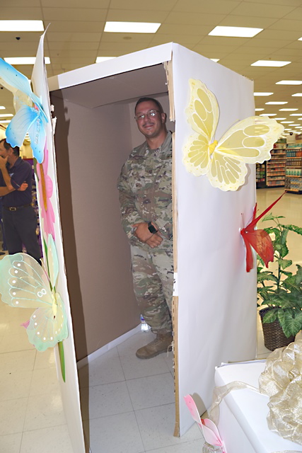 SSgt. Hector Acosta stands in the box that his daughter would soon open to find that her daddy had returned from deployment earlier than expected.