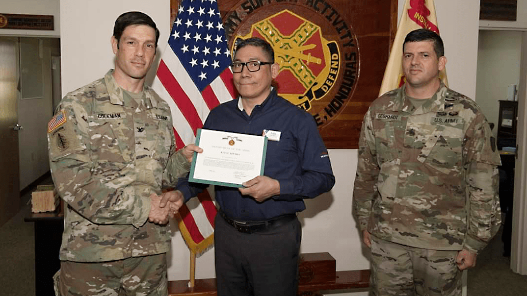 Luis Rivera, Honduras Exchange store manager, receives the Commander’s Award for Civilian Service from garrison commander Col. Michael Coleman and Command Sgt. Maj. Jeremy Gebhardt.