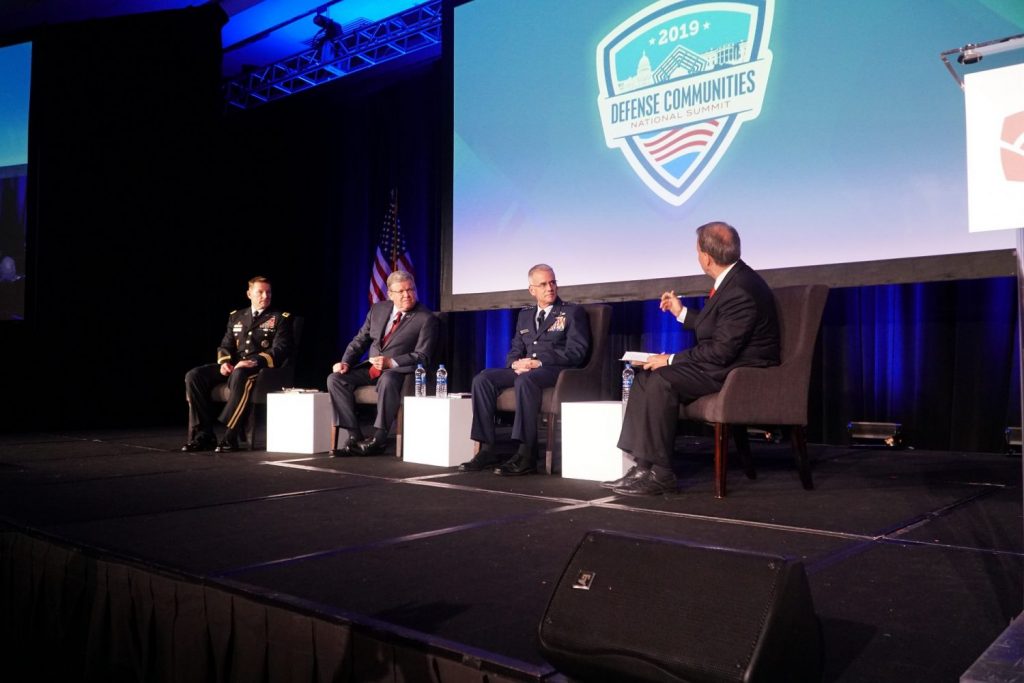 Military and Exchange leaders sit on a stage discussing modern campus dining