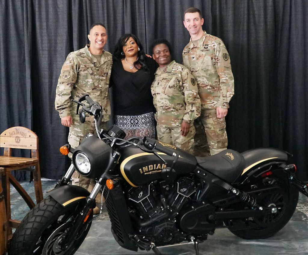 Exchange military leaders celebrated retired Staff Sgt. Cheryl Davis, winner of the Jack Daniels Indian Motorcycle Sweepstakes on June 26. From left: Chief Master Sgt. Luis Reyes, Exchange senior enlisted advisor; Davis; Sgt. Maj. Julia Henry, Europe/Southwest Asia Region senior enlisted advisor; and Col. Scott McFarland, Europe/Southwest Asia Region commander.