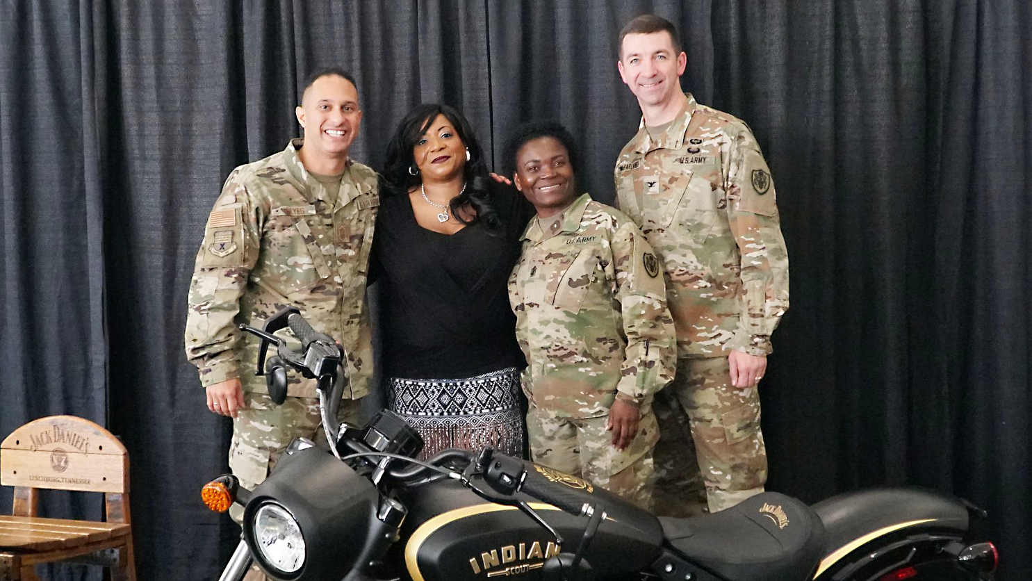 Exchange military leaders celebrated retired Staff Sgt. Cheryl Davis, winner of the Jack Daniels Indian Motorcycle Sweepstakes on June 26. From left: Chief Master Sgt. Luis Reyes, Exchange senior enlisted advisor; Davis; Sgt. Maj. Julia Henry, Europe/Southwest Asia Region senior enlisted advisor; and Col. Scott McFarland, Europe/Southwest Asia Region commander.