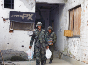 U.S. Soldiers leave an Exchange at Bosnia's Camp Comanche, 1998.