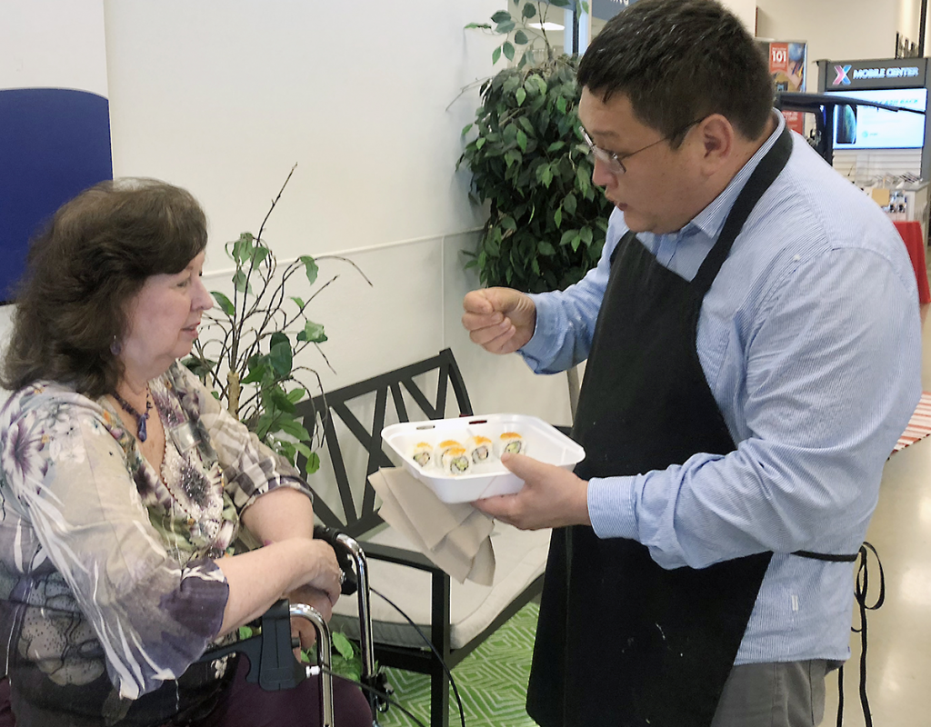 LITTLE ROCK AFB, Ark. - Odbayar "Ocko" Ulziibuyan, owner of Ocko's Sushi Bar, offers samplings of his food to a customer. Ocoko's restaurant opened Aug. 5 in the food court. The restaurant offers California rolls, spicy crawfish rolls, crunchy shrimp and more. “The Little Rock Exchange is committed to bringing healthy, BE FIT dining options to Airmen and families,” said Exchange General Manager Donald Cantwell. “We’re excited to bring more choices to the community.”