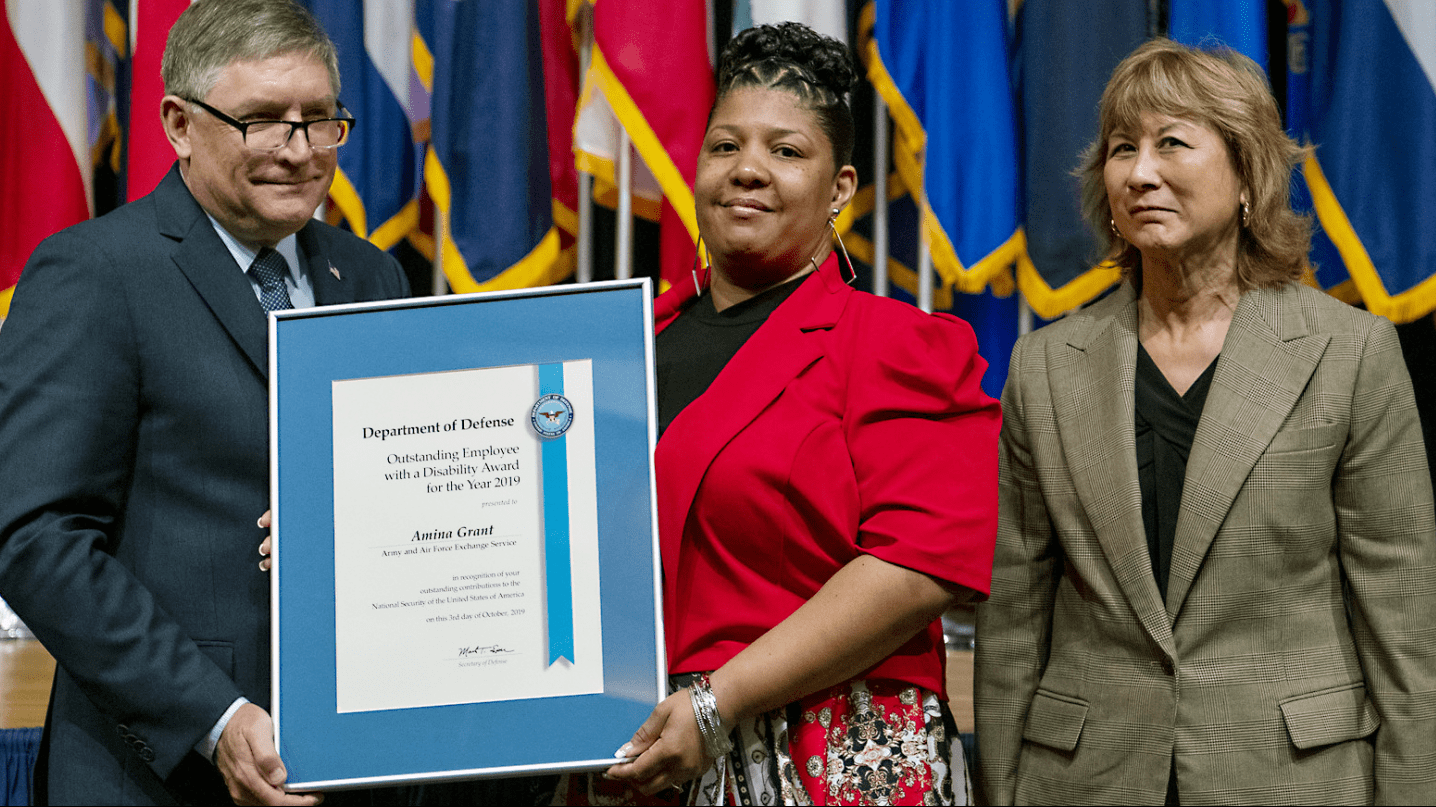 Exchange EVP and Chief Logistics Officer Karen Stack, right, joins Under Secretary of Defense for Personnel and Readiness James Stewart and Exchange associate Amina Grant at the awards ceremony.