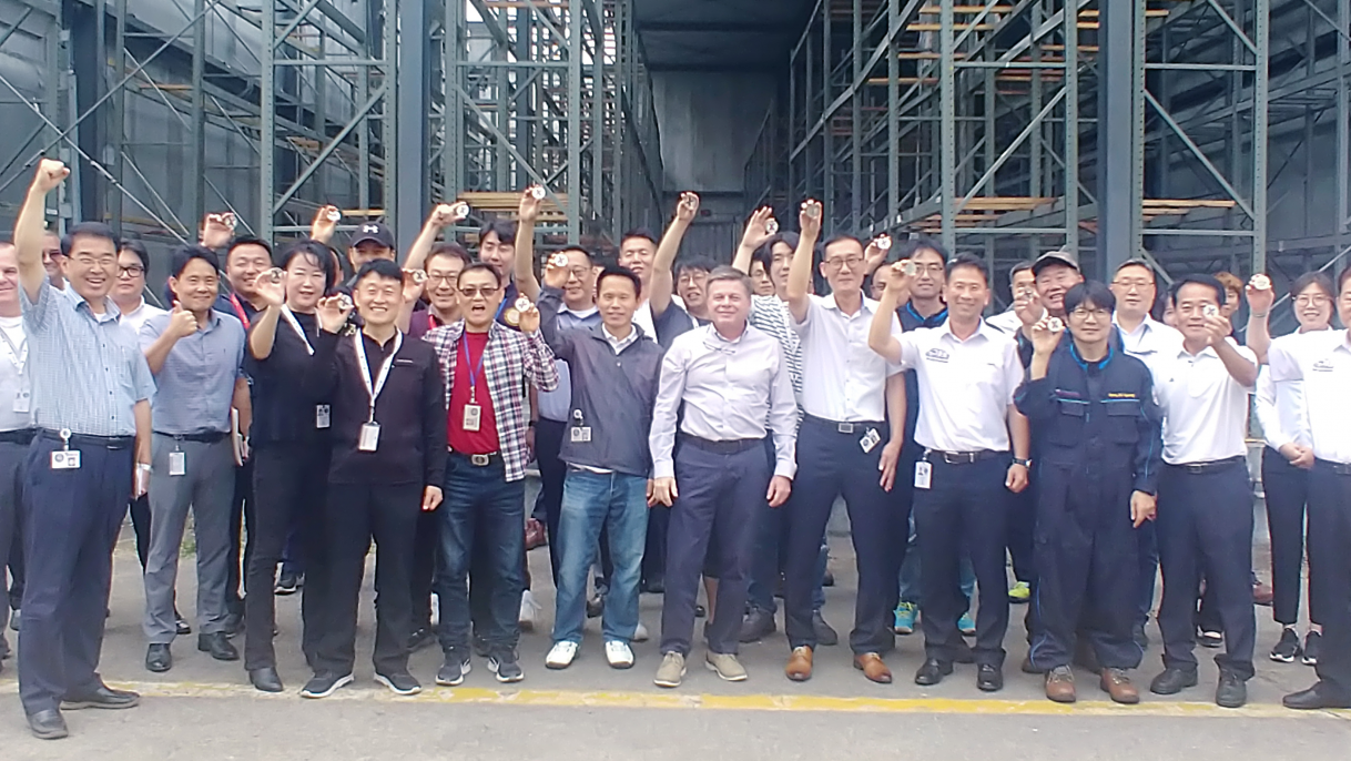 EVP and Chief Operating Officer Dave Nelson, center, with coin recipients and other members of the Korea Distribution Center.