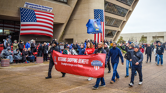 With the wind a little calmer, Exchange managers and associates pass in front of the Dallas City Hall. The 2019 Veterans Day Parade was held to commemorate the 75th anniversary of the Normandy invasion.