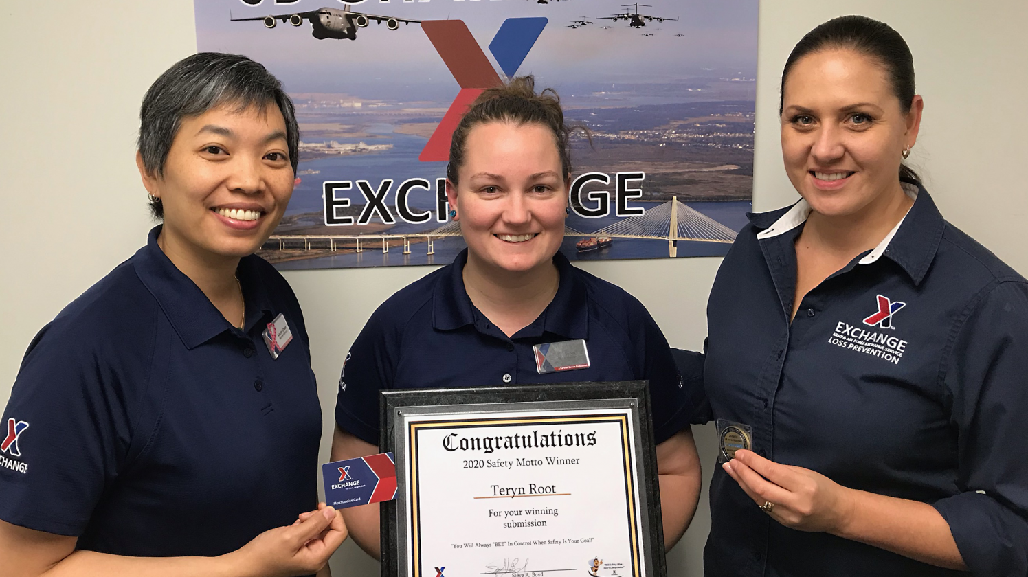 JB Charleston General Manager Keola Chan and Loss Prevention Manager Julia Santiago present Teryn Root with her prizes.