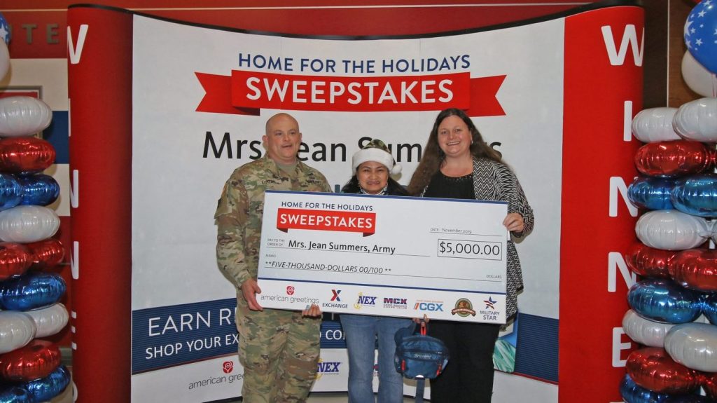 Fort Stewart Garrison Commander Col. Bryan Logan and Exchange General Manager Hollie Heft Morales, right, present Army sweepstakes winner Jean Summers with her prize. Photo by SSG Todd Pouliot