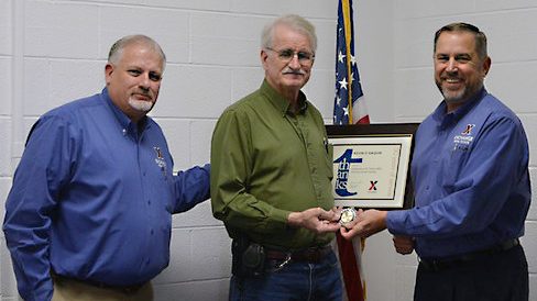 From left, Facility Manager Ray Estes, 50-year associate Kevin Gaquin and Real Estate Directorate Senior Vice President Mike Smietana mark Gaquin’s achievement.      