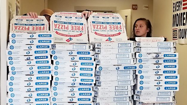 Quarantined paratroopers at Fort Bragg look over the pizzas delivered to them by the Exchange's Domino's associates.