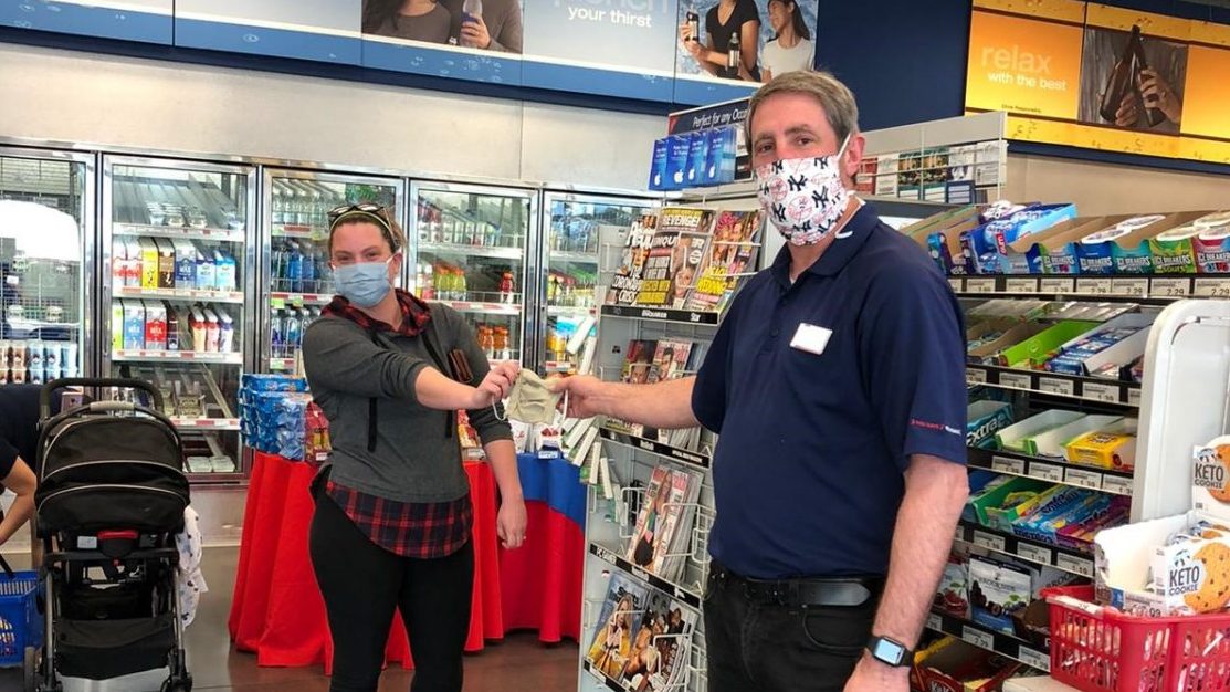 Ashley Everett hands one of her masks to Netzaberg Express Manager Ray Zumwalt.