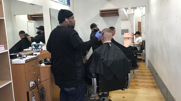 Exchange barbers at Fort Lee practice social distancing while giving Soldiers military haircuts