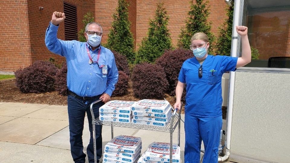 Domino's Elisa Hicks delivers pizza to a staff member of Fort Bragg's Womack Army Hospital.