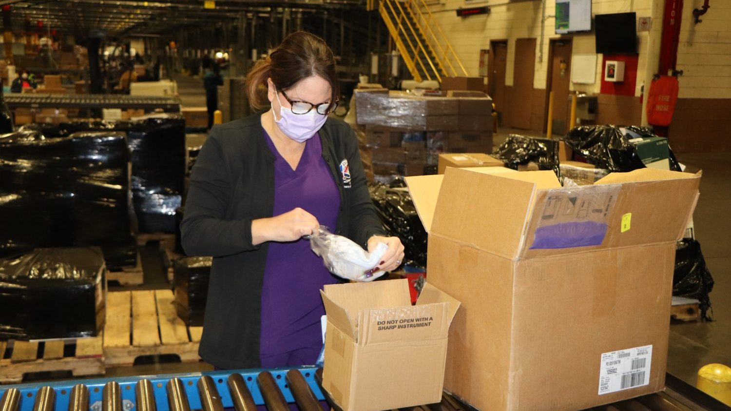 Lori Penny, Dan Daniel Distribution Center occupational health nurse, received her Exchange-issued face mask. 