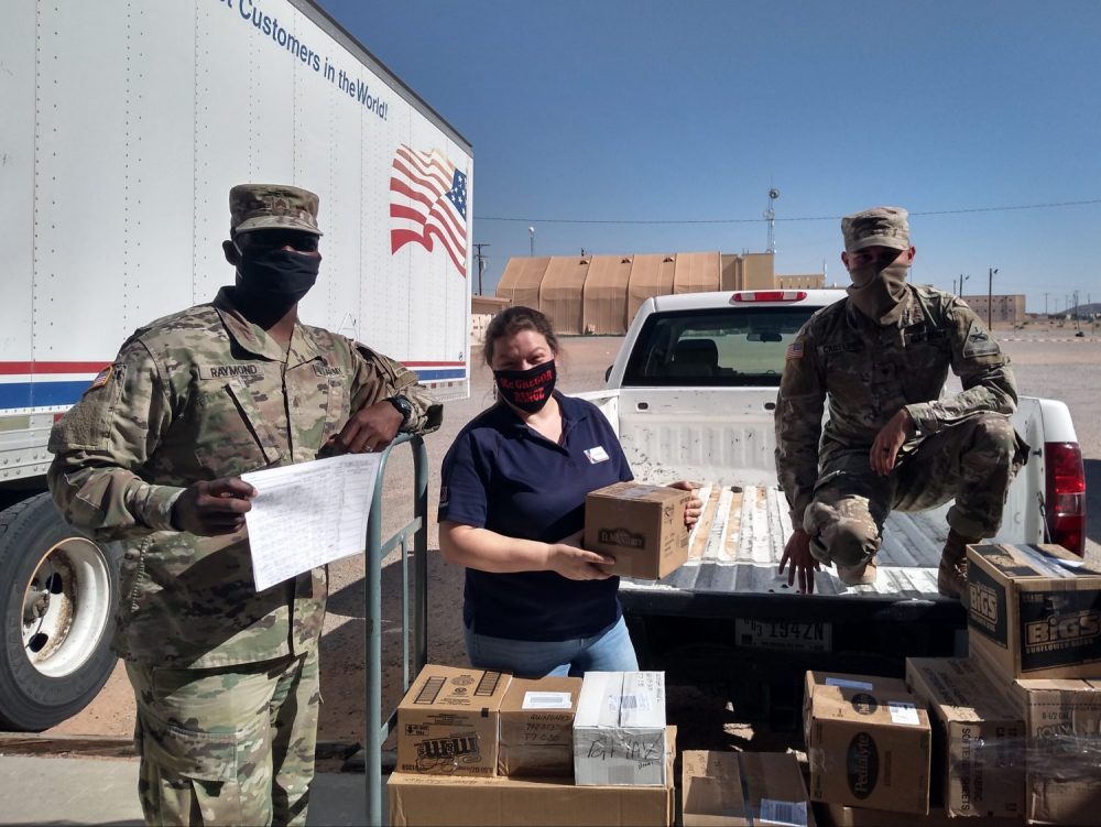 Sgt. Tehjmar Raymond (left) and Spc. Nathaniel Causley (right) help McGregor Field Troop Store Manager Tina Bretz load orders placed through the Fort Bliss Exchange’s personal shopper program onto a truck to be transported to quarantined Soldiers at Fort Bliss.