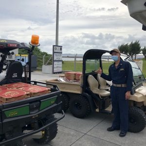 Sailor poses with pizzas delivered by the Exchange